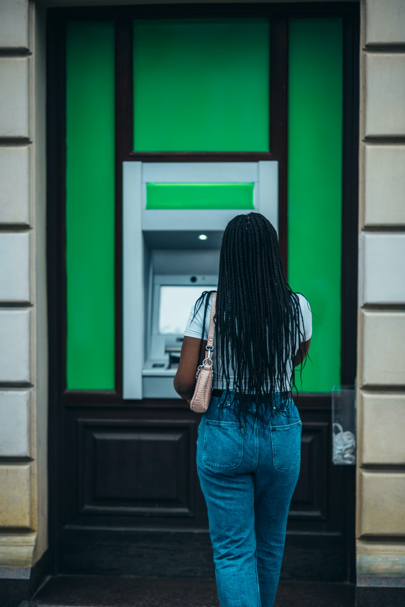 African american woman using a atm machine